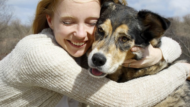 Close up of Woman Hugging German Shepherd Dog